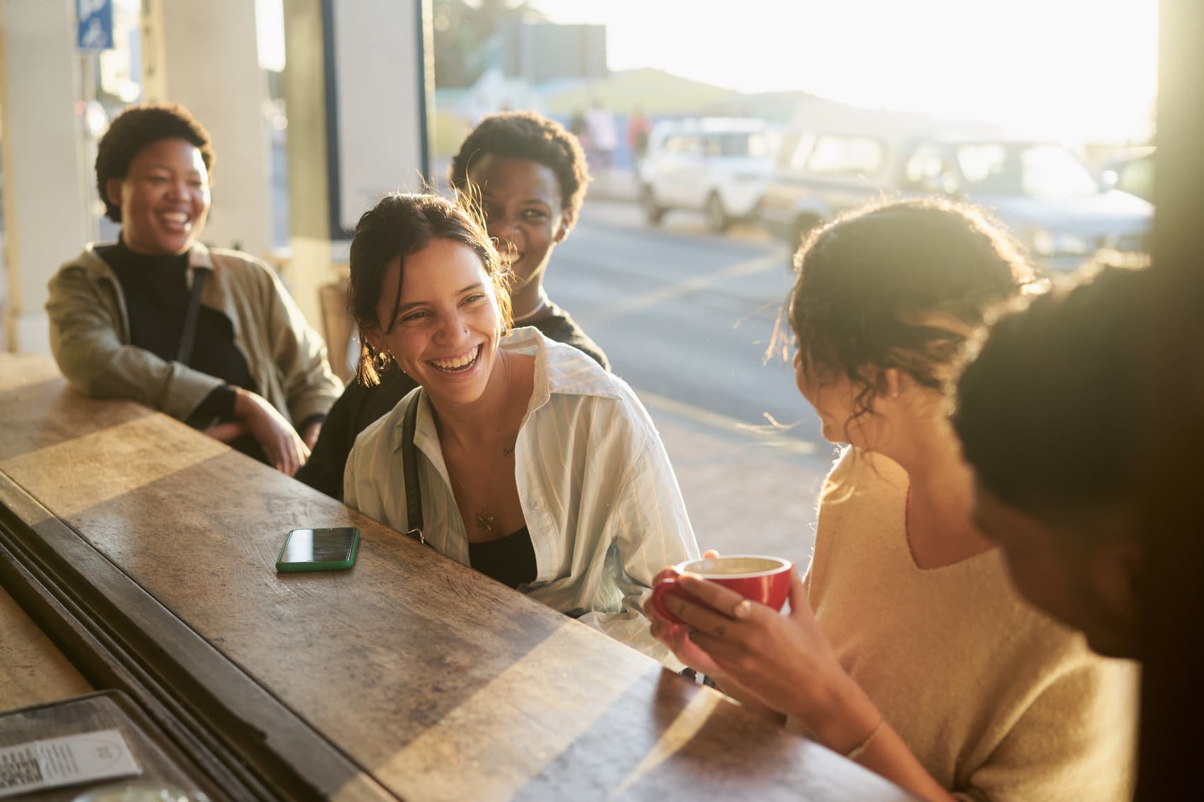 Friends talking over coffee at a local coffee shop